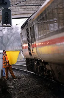 Two Men Only Prints: A British Rail workman using the old fashioned hand and flag signal on 1st, December 1994