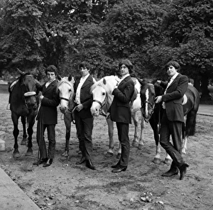 Horse Prints: British rock group The Kinks pose on horses in the gardens opposite the Flaghouse in
