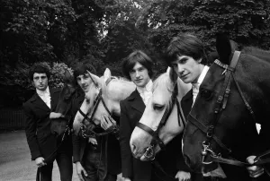 British rock group The Kinks pose on horses in the gardens opposite the Flaghouse in