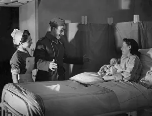 Surprise Prints: A British serviceman looks surprised as his wife presents him with a newborn baby