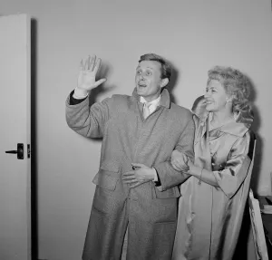 British singer and actor Gary Miller with his wife Joy wave goodbye to their children as