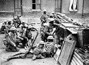 British soldiers take cover behind a barricade in Bailleul in anticipation