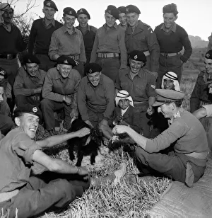 British soldiers and local Arab men enjoy a feast in Jordan. March 1952 C1287-001