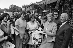 01091 Prints: British Tennis player Ann Jones (3rd from right) signs autographs for her young fans
