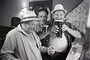 Obese Prints: British tourists enjoying a litre of beer whilst on holiday in Spain June 1965