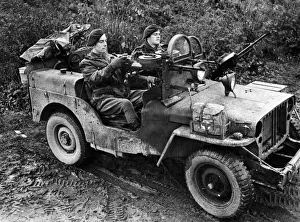 01467 Prints: British troops drive into Germany. A jeep manned by Sergeant A Schofield