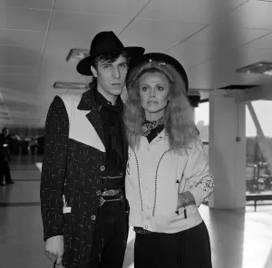 00840 Prints: Britt Ekland with boyfriend Slim Jim McDonnell at Heathrow Airport. 16th November 1982