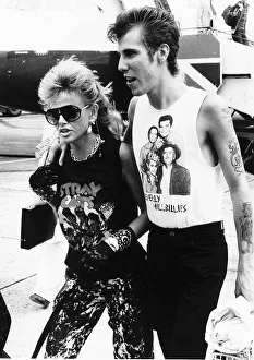 Fashions Prints: Britt Ekland with her boyfriend Slim Jim McDonnell pictured here at Heathrow Airport