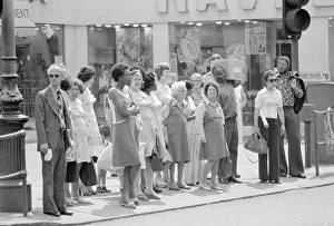 Peace Prints: Brixton Community shoppers at lunch time crossing the Brixton Road by the Underground