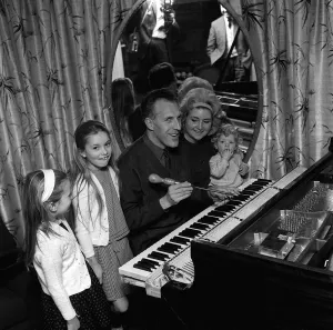 00504 Prints: Bruce Forsyth with Family 1964 Comedian with wife and children playing at piano