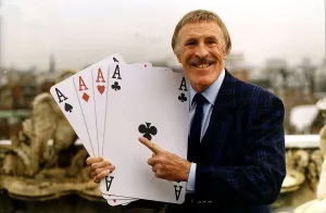 Bruce Forsyth TV Presenter Holding playing cards which are used on his hit tv show Play