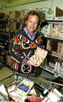 Bruno Brookes Disc jockey and TV Presenter holding open a carton of eggs while doing