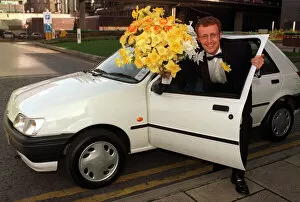Images Dated 5th March 1997: Bryan Burnett TV Presenter with a Ford Fiesta and a bottle of Whisky prizes at the Marie