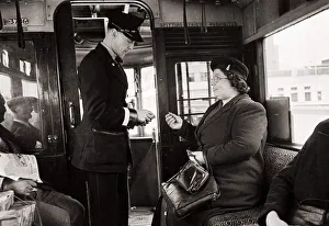 Bus Conductor Prints: Bus Conductor collecting fares for passengers - circa 1948