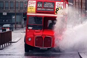 Landscape Prints: A bus splashing through a large puddle of water after a heavy rainfall in London