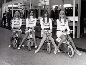 Mopeds Prints: Business Efficiency Exhibition. Four mini-skirted messenger girls sit on their Electric