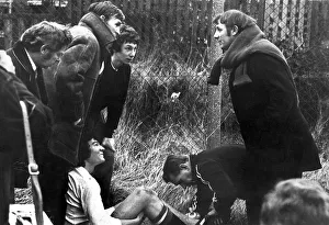Its down to business straight away as Tommy Docherty talks to an injured Manchester