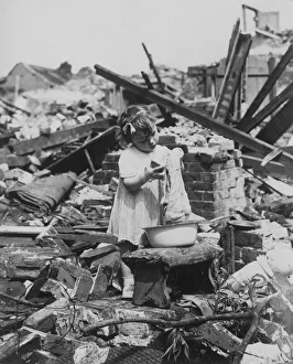 Business as usual for this little girl as she changes her toy dolls clothes