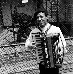 00024 Prints: Busker Albert Puschase Seen here playing his accordion to vistors at London Zoo