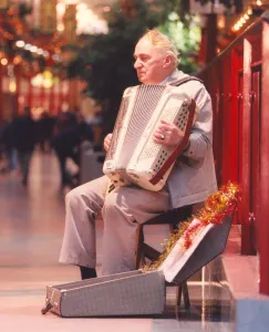 Busker Terry Larke playing his accordian in Cramlingtons shopping centre
