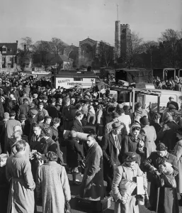 Towns Prints: Busy scenes showing crowds of people gathered at the cattle market beside the River