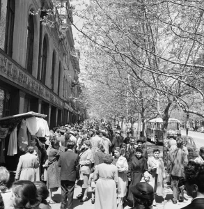 Busy street scene showing people shopping for clothes in the Soviet city of Tiflis