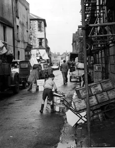 00176 Prints: A busy street scene as traders, workmen and children go about their business