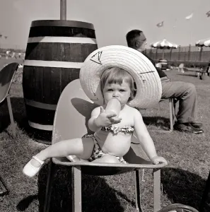 Camp Prints: Butlins Holiday Camp at Bognor A Little toddler wearing a floral bikini sucking