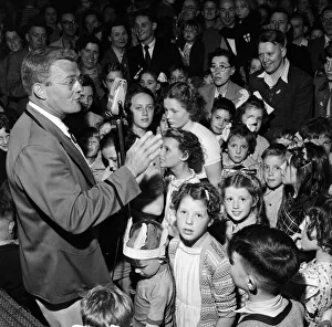 Camp Prints: A Butlins Redcoat entertaining families at a Butlins Holiday Camp. June 1954