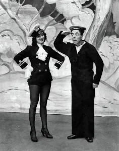 Buttons (Duggie Wakefield) takes his orders from Dandini (Pat Kirkwood