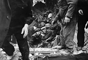 Casualties Prints: C. D workers helping a causality from blitzed premises after his rescue