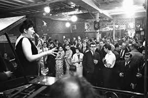 Drinkers Prints: Cabaret singer performing in a East End of London pub on a Saturday night. 6th July 1963