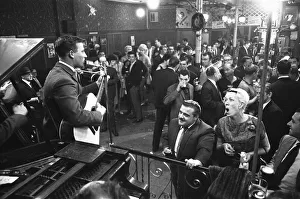 00959 Prints: Cabaret singer performing in a East End of London pub on a Saturday night. 6th July 1963