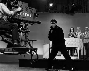 The camera swings in to record American Fifties Sixties pop singer Gene Vincent