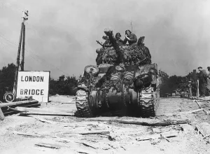 A camouflaged Sherman Firefly tank of the 7th Armoured Division seen here moving up to