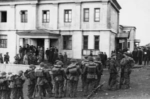 01461 Prints: Canadian guard hear a mission briefing outside a communal building in Barentsburg