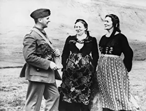 A Canadian officer chats with two Icelandic women in their native costume during Second