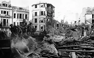 01469 Prints: Canadian soldiers help to remove debris from bombed buildings on Hastings. 8th May 1943