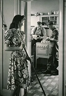 00065 Prints: Canadian soldiers washing-up while english woman sweeps floor Circa 1940