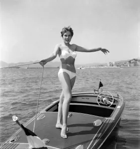 Cannes Prints: Cannes Film Festival 1953. Lise Michaud seen here modeling a bikini on a speed boat just