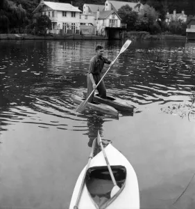 00011 Prints: Canoeist Dave Pegram testing his water boots invention on the river