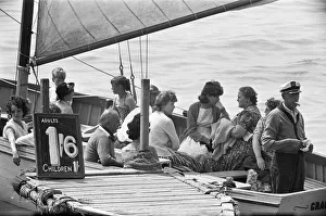 Holidaymaker Prints: The captain of the Grace Darling has a sandwich whilst waiting to fill his boat with