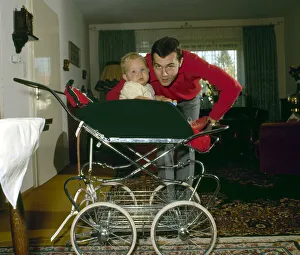 Pram Prints: Captain of the West Germany football team Franz Beckenbauer pictured at home with his son