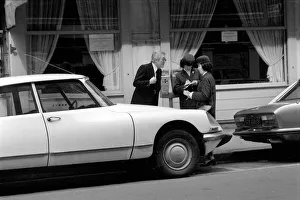 Parking Meter Prints: A car driver protesting to traffic wardens after they put a ticket on his car in Paris