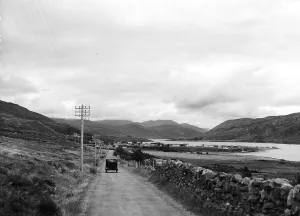 Rural Scene Prints: A car driving alond an empty country road by Loch Broom near Ullapool on the west coast