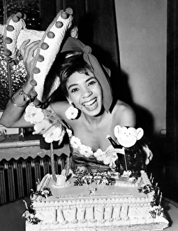 Cardiff-born singer Shirley Bassey is pictured celebrating her 19th birthday with a cake