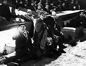 Cardiff City manager Jimmy Scoular tries to hide the face of City centre half Don Murray