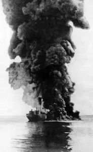 German Navy Prints: A cargo steamer hit by a u-boat torpedo seen here burning and sinking by the bow