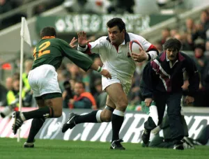 Will Carling runs at Hennie le Roux at the International match at Twickenham