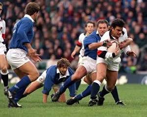 Determination Prints: Will Carling is tackled as he tries to break the Italian defence during the England v